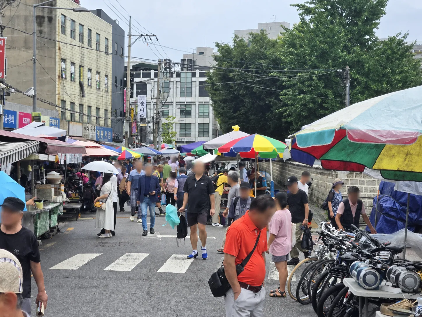 Crowded Dongmyo Flea Market street beside the historic shrine wall in Seoul