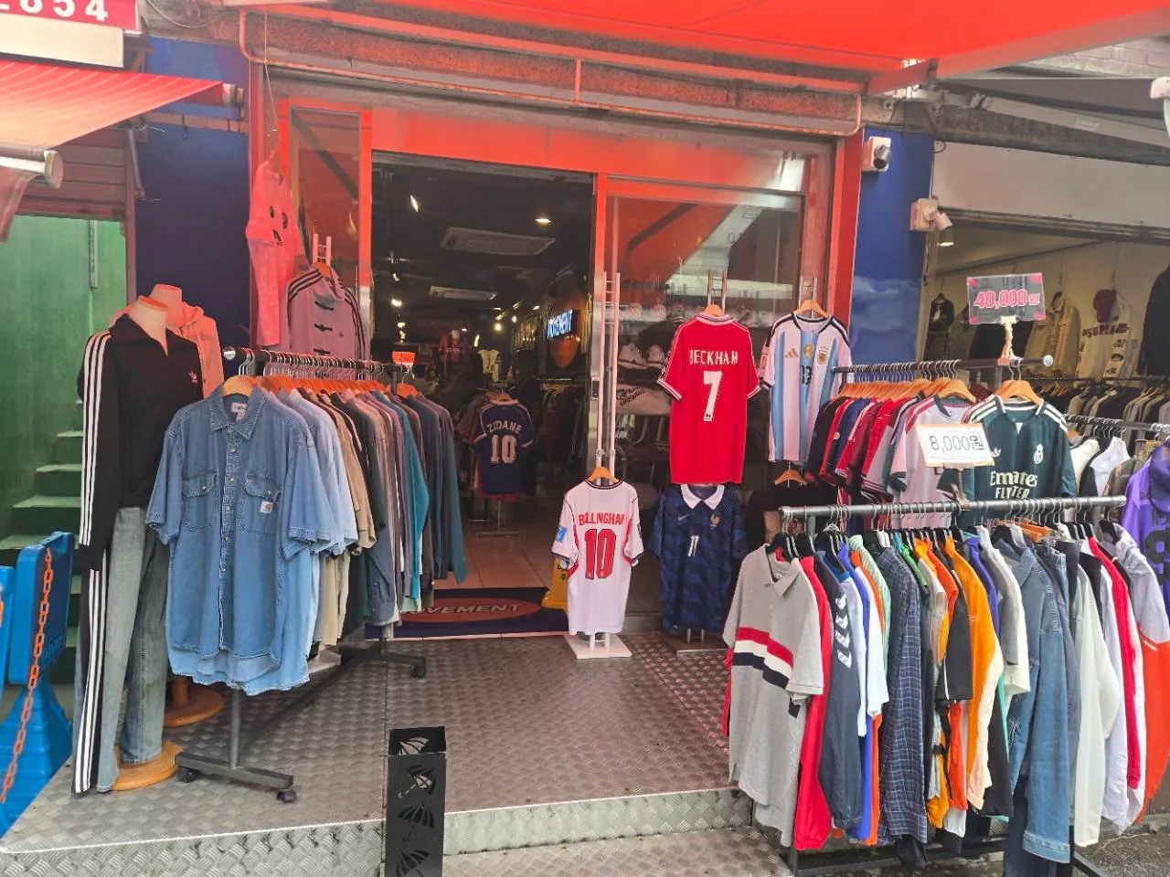 Football jerseys and vintage sportswear outside a Dongmyo clothing shop