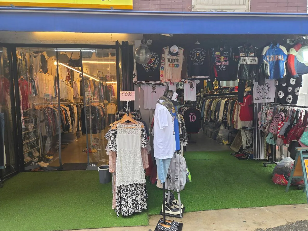 Vintage clothing and sports shirts displayed outside a Dongmyo market shop