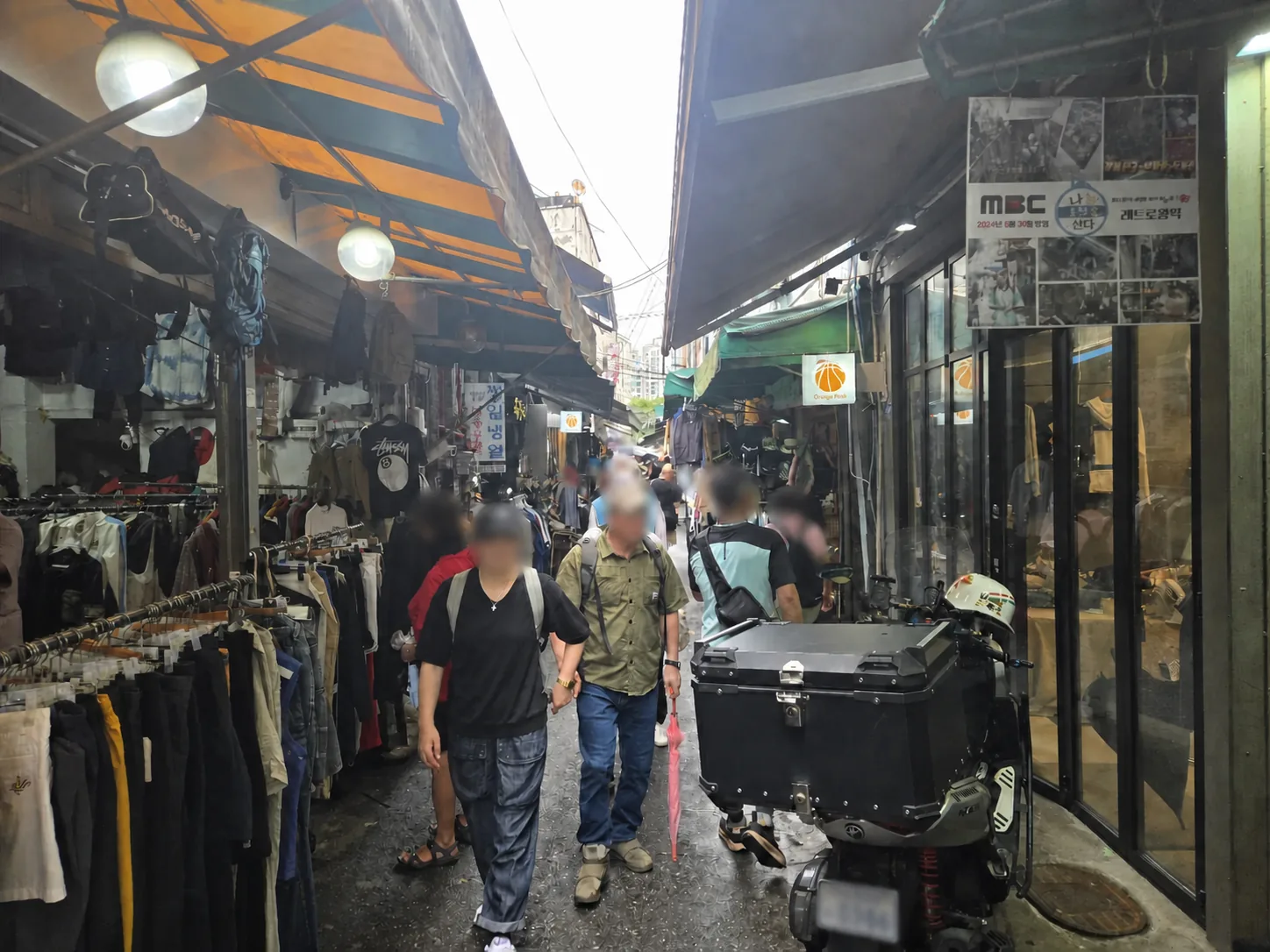 Narrow vintage clothing alley inside Dongmyo Flea Market in Seoul