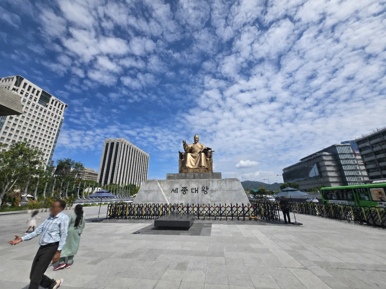 King Sejong the Great statue at Gwanghwamun Square under a blue sky