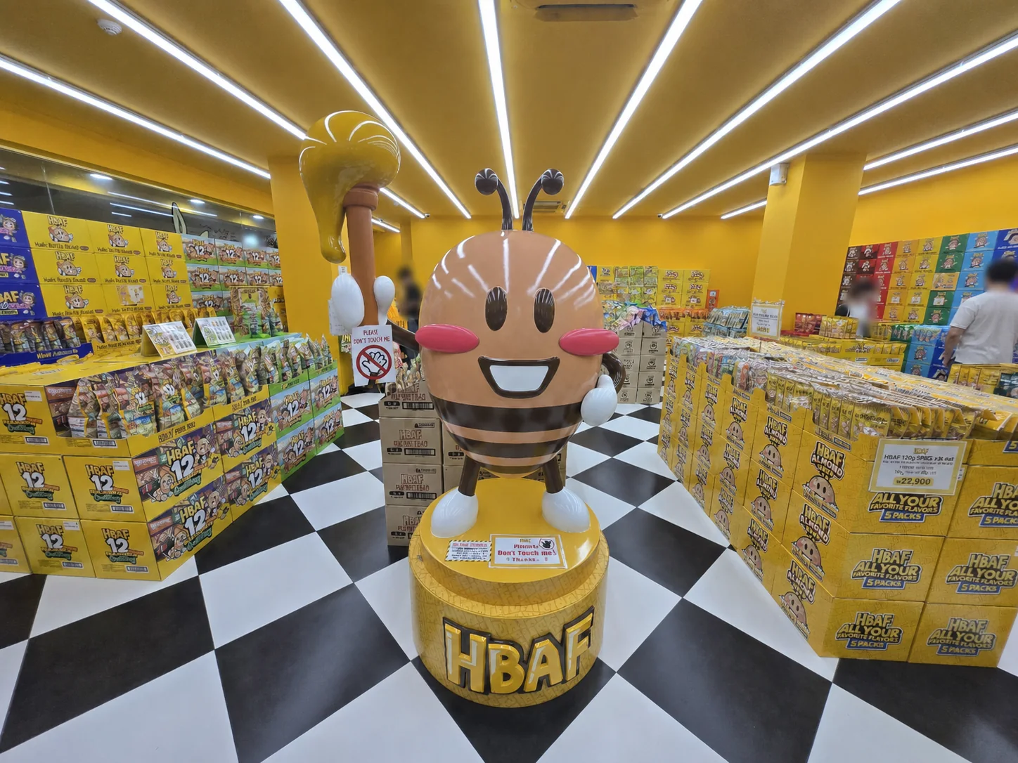 Bright yellow interior and almond mascot at the HBAF Gwangjang Market store