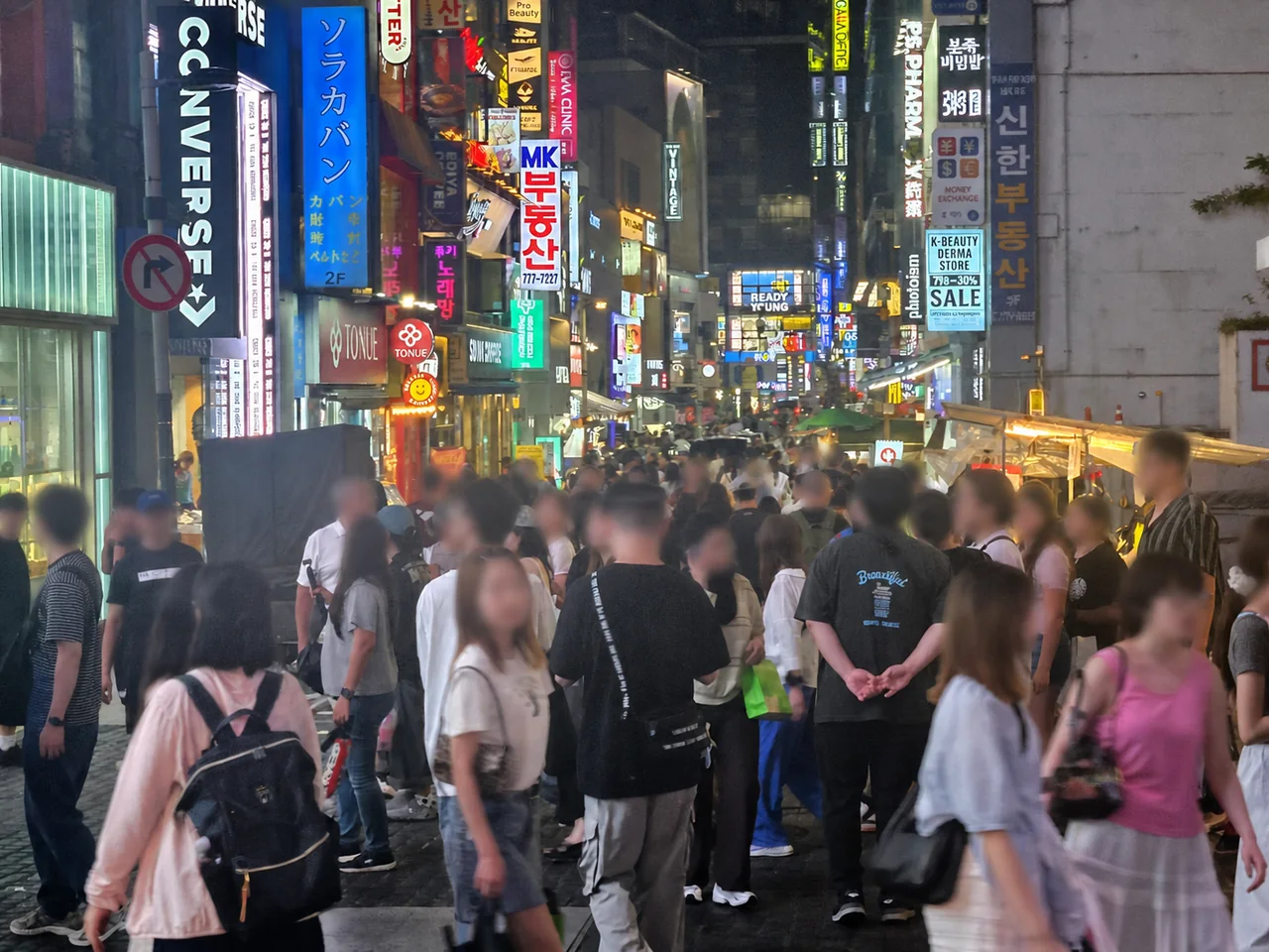 Crowded Myeongdong street food area at night in Seoul