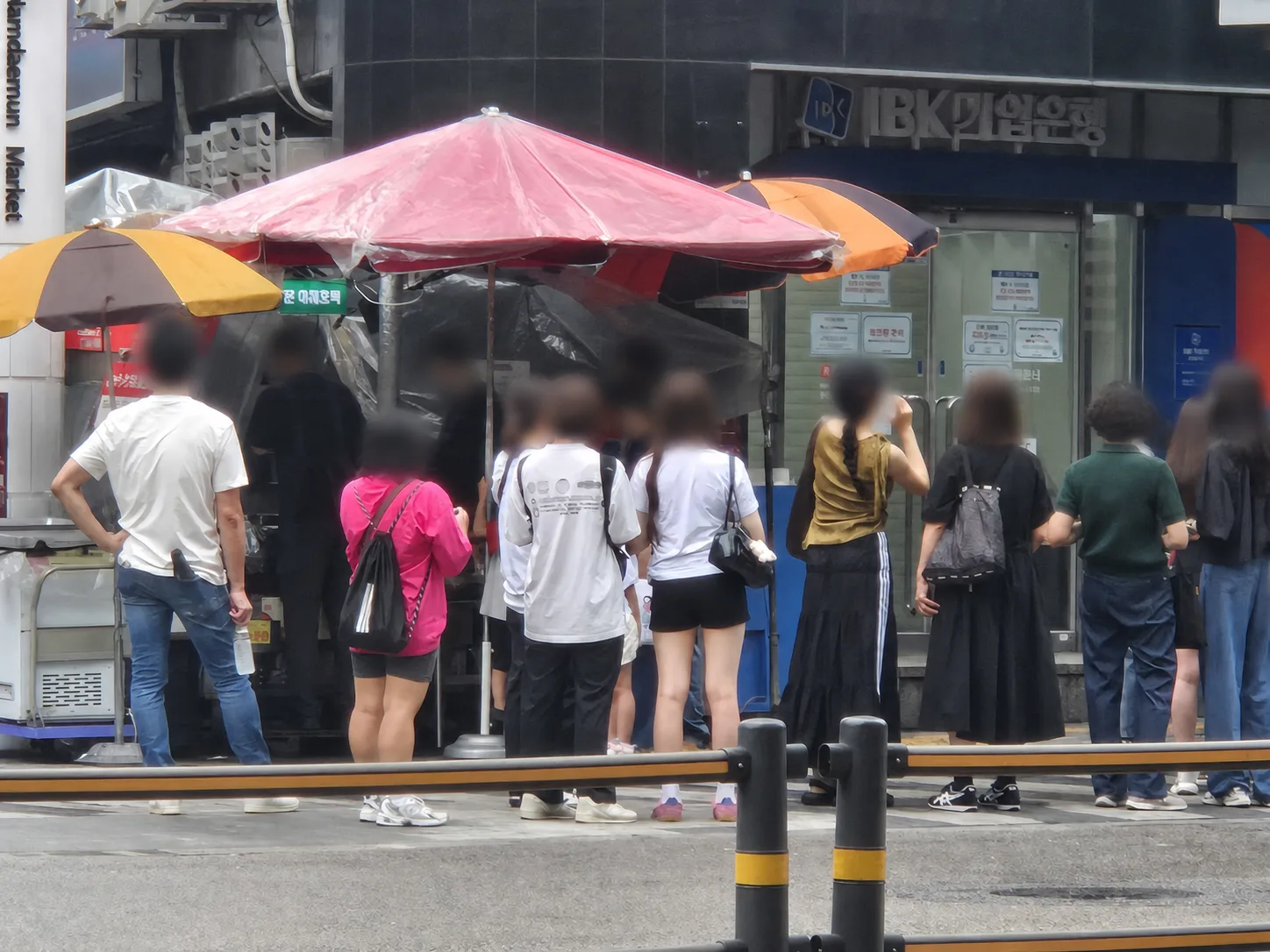 Morning queue at the Namdaemun vegetable hotteok stall beside IBK Bank