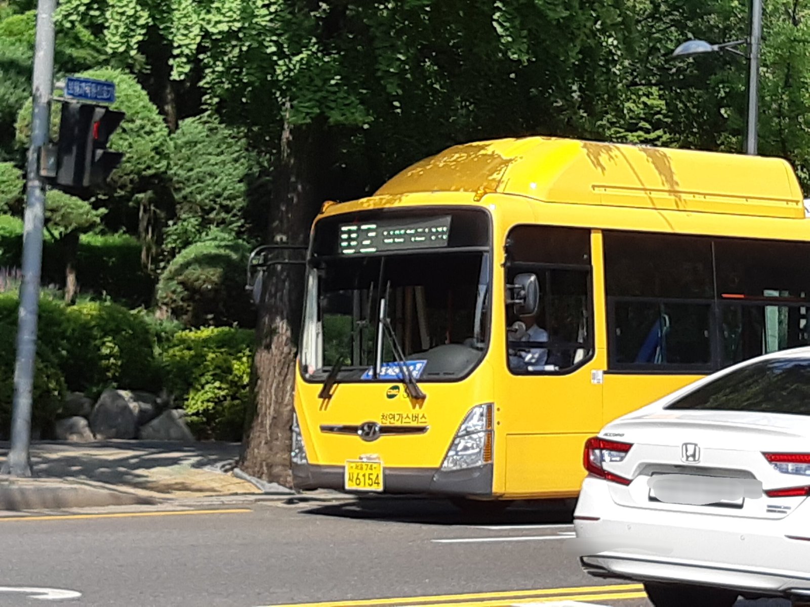 Blue Seoul city bus arriving at a bus stop