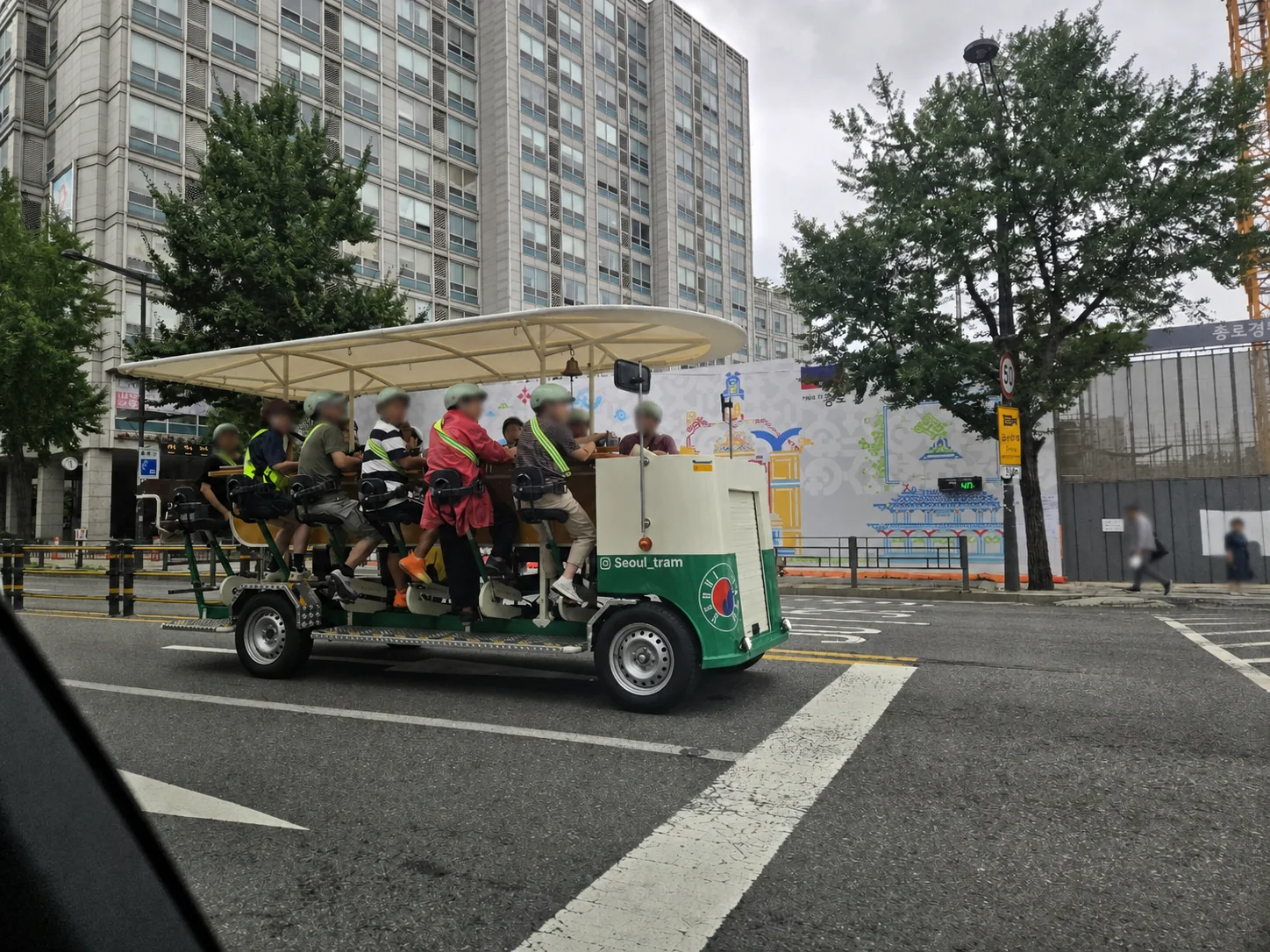 Pedal-assisted Seoul Tram sightseeing vehicle carrying passengers near Gwanghwamun