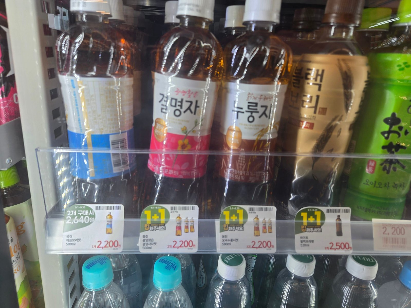 1+1 drink promotion labels in a Korean convenience store