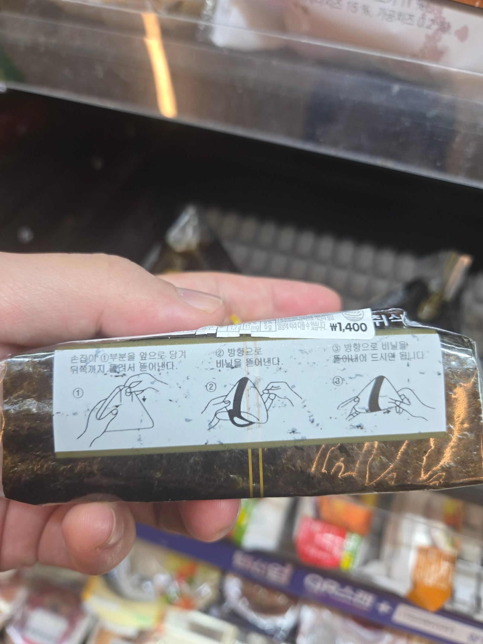 Triangle kimbap wrapper with Korean opening instructions