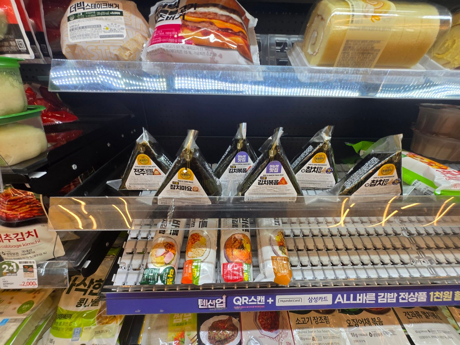 Triangle kimbap and packaged Korean meals in a convenience store display