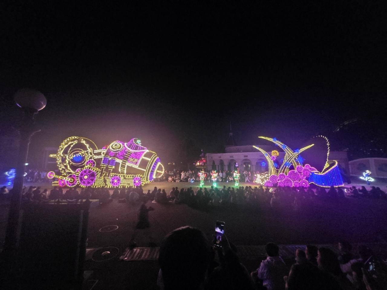 Colorful illuminated parade floats moving through Everland at night