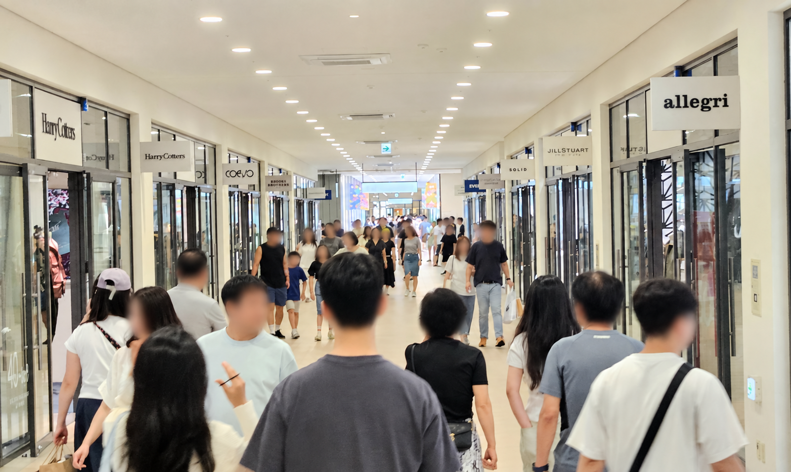 Busy fashion-brand corridor inside Hyundai Premium Outlet Gimpo