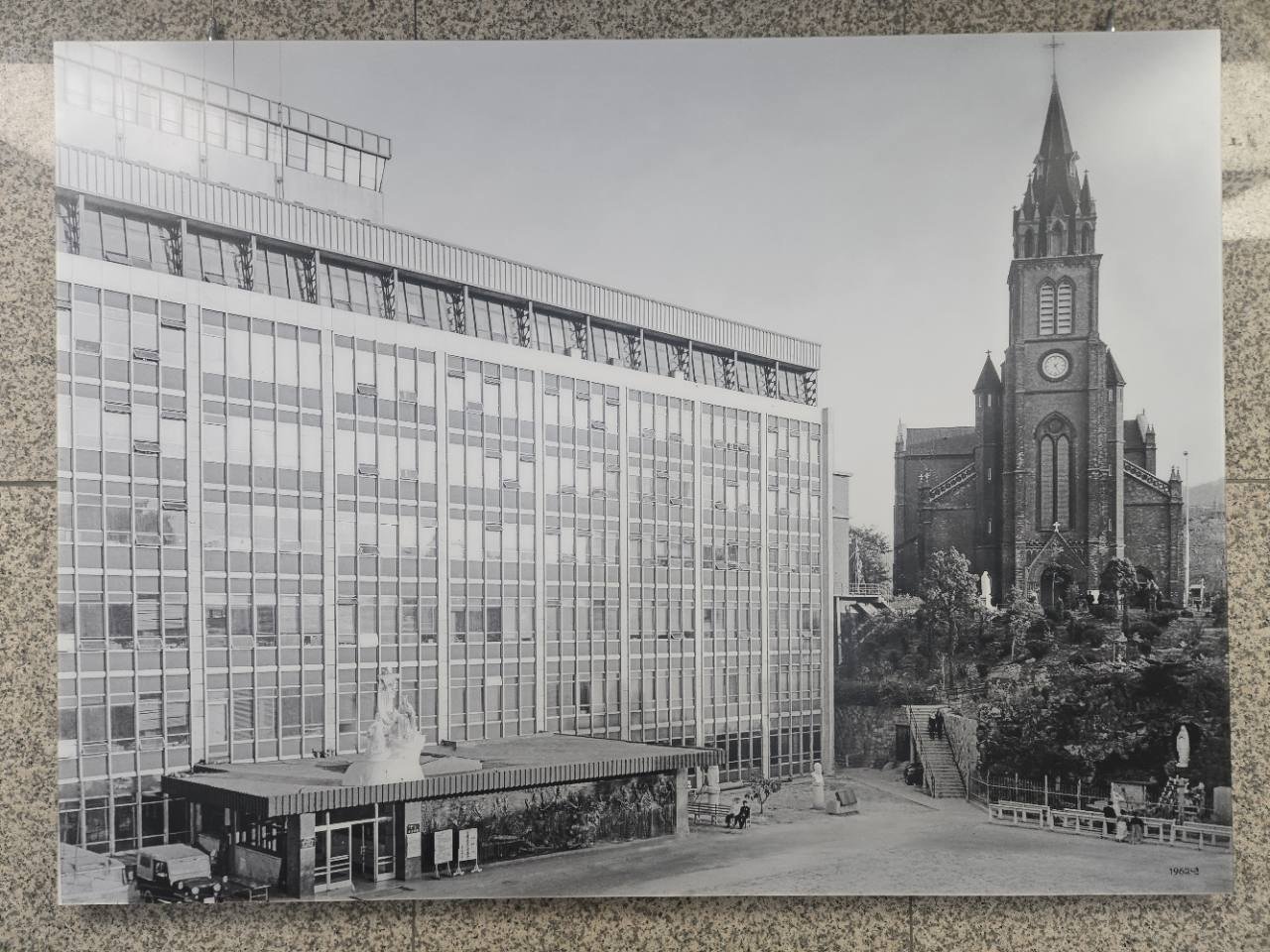 Historic black-and-white photograph showing Myeongdong Cathedral and the surrounding city