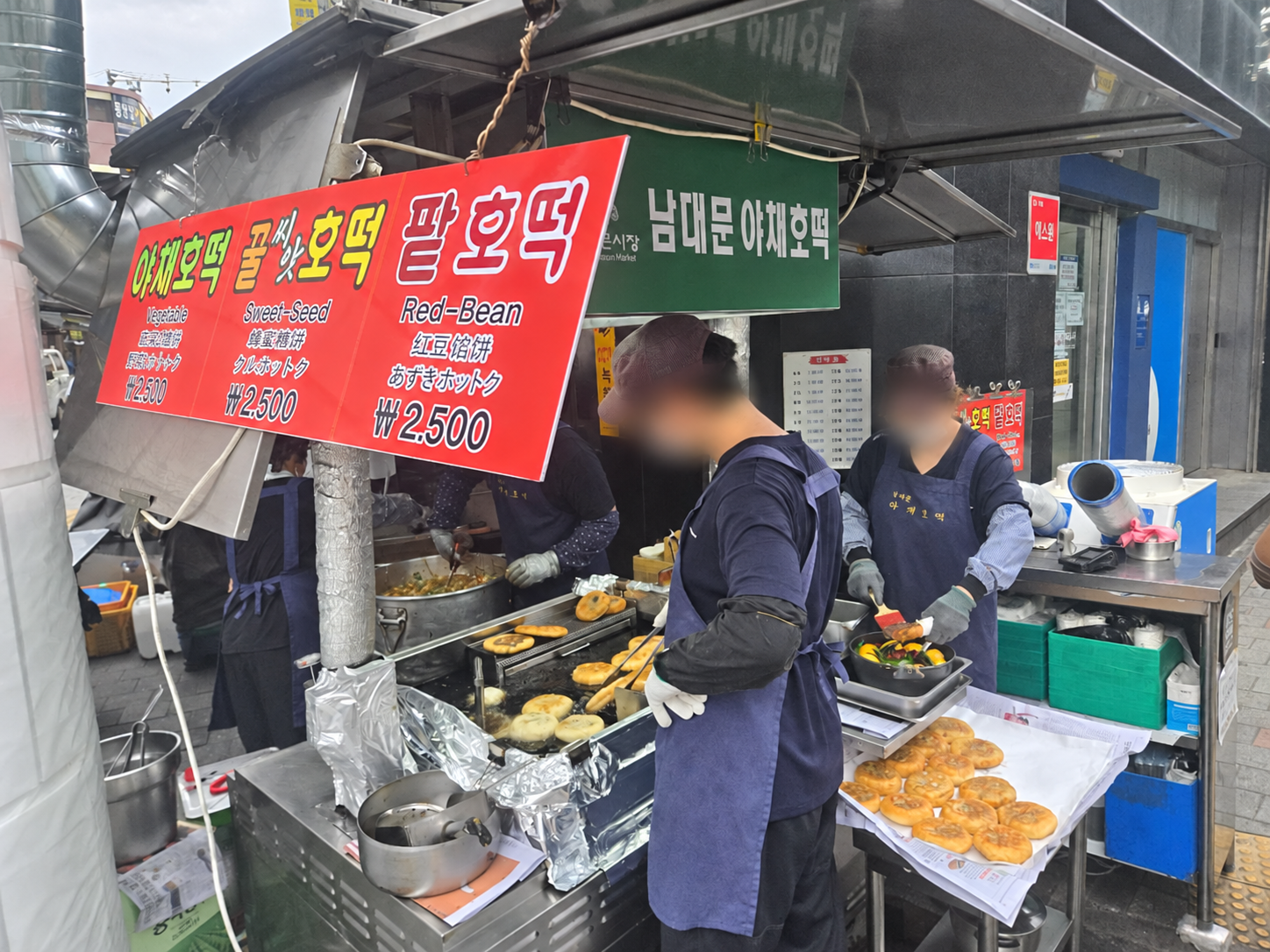 Namdaemun vegetable hotteok stall with menu sign and freshly cooked pancakes