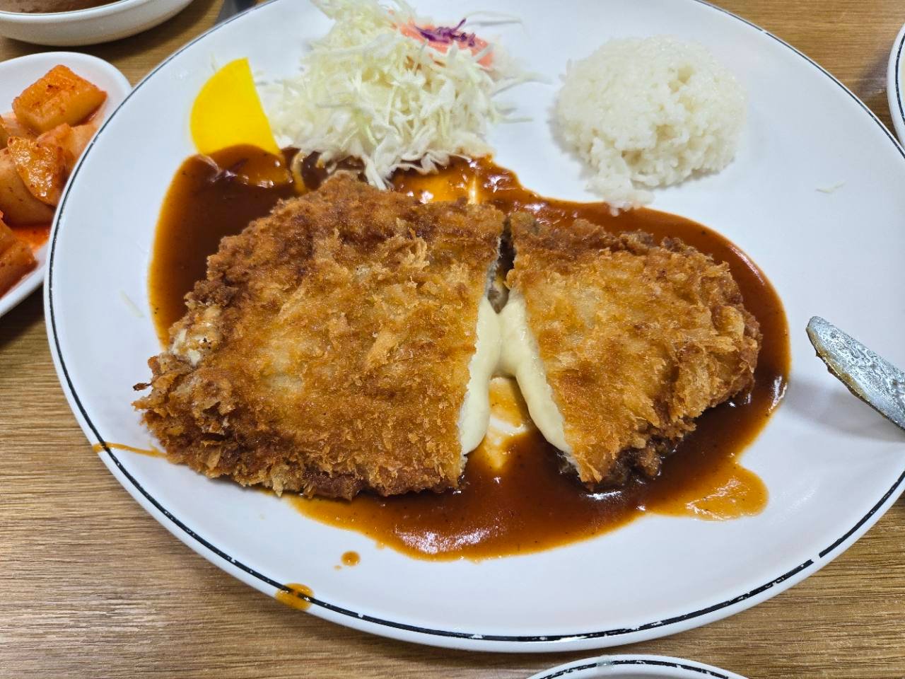 Cheese-filled king pork cutlet with rice and cabbage at Original Namsan King Pork Cutlet