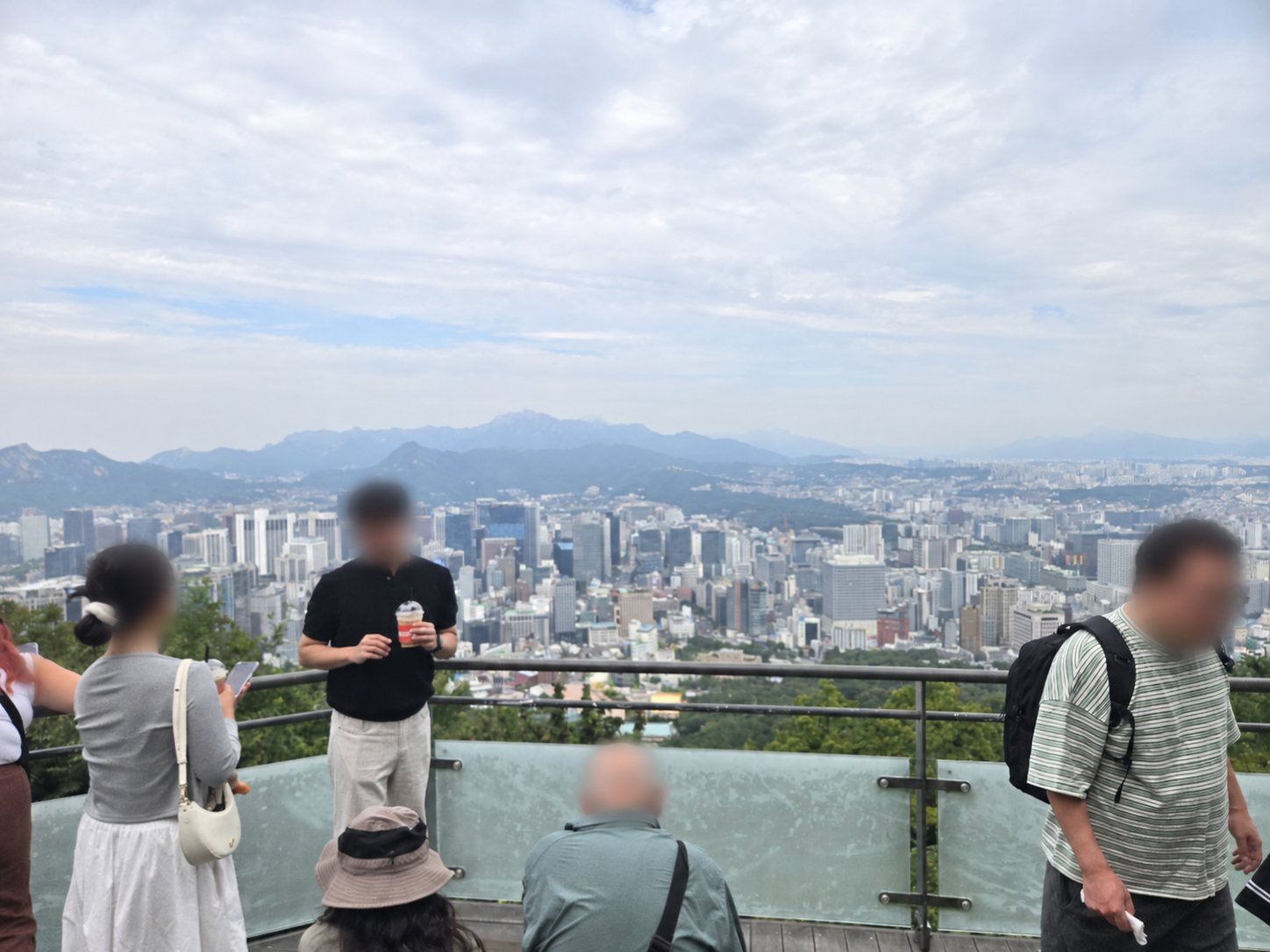 Wide daytime view of central Seoul from an outdoor terrace on Namsan