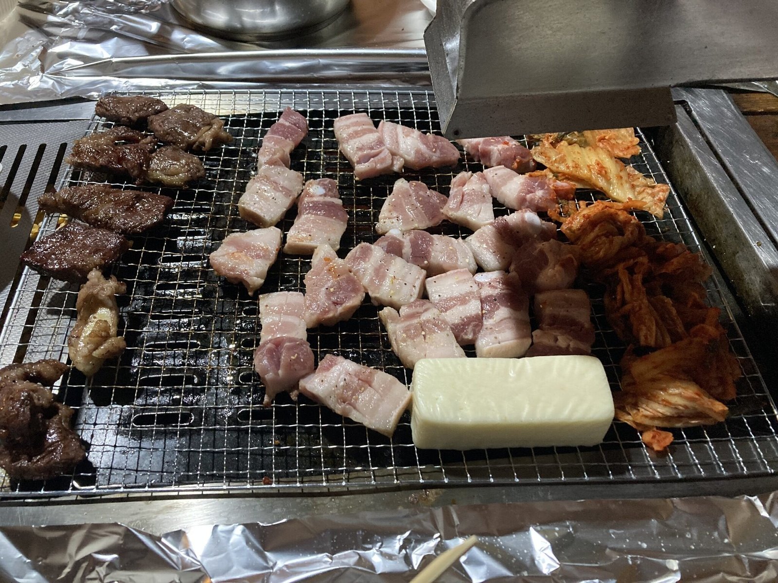 Korean BBQ grill with samgyeopsal, beef and kimchi in Seoul
