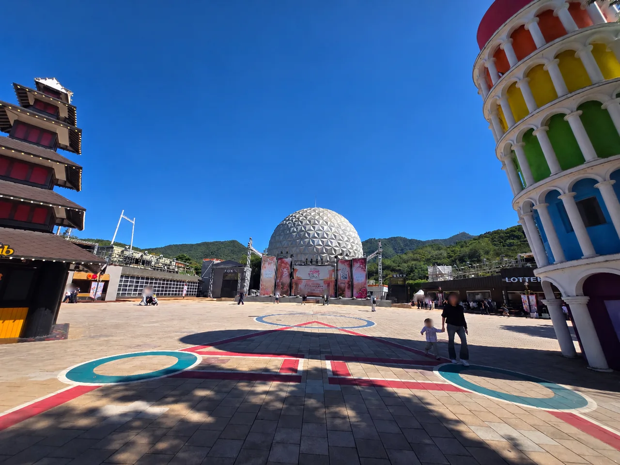 Open plaza at Seoul Land with a colorful tower and the geodesic dome beyond