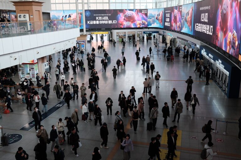 Travelers and ticket counters in Seoul Station’s main concourse, photographed in March 2026