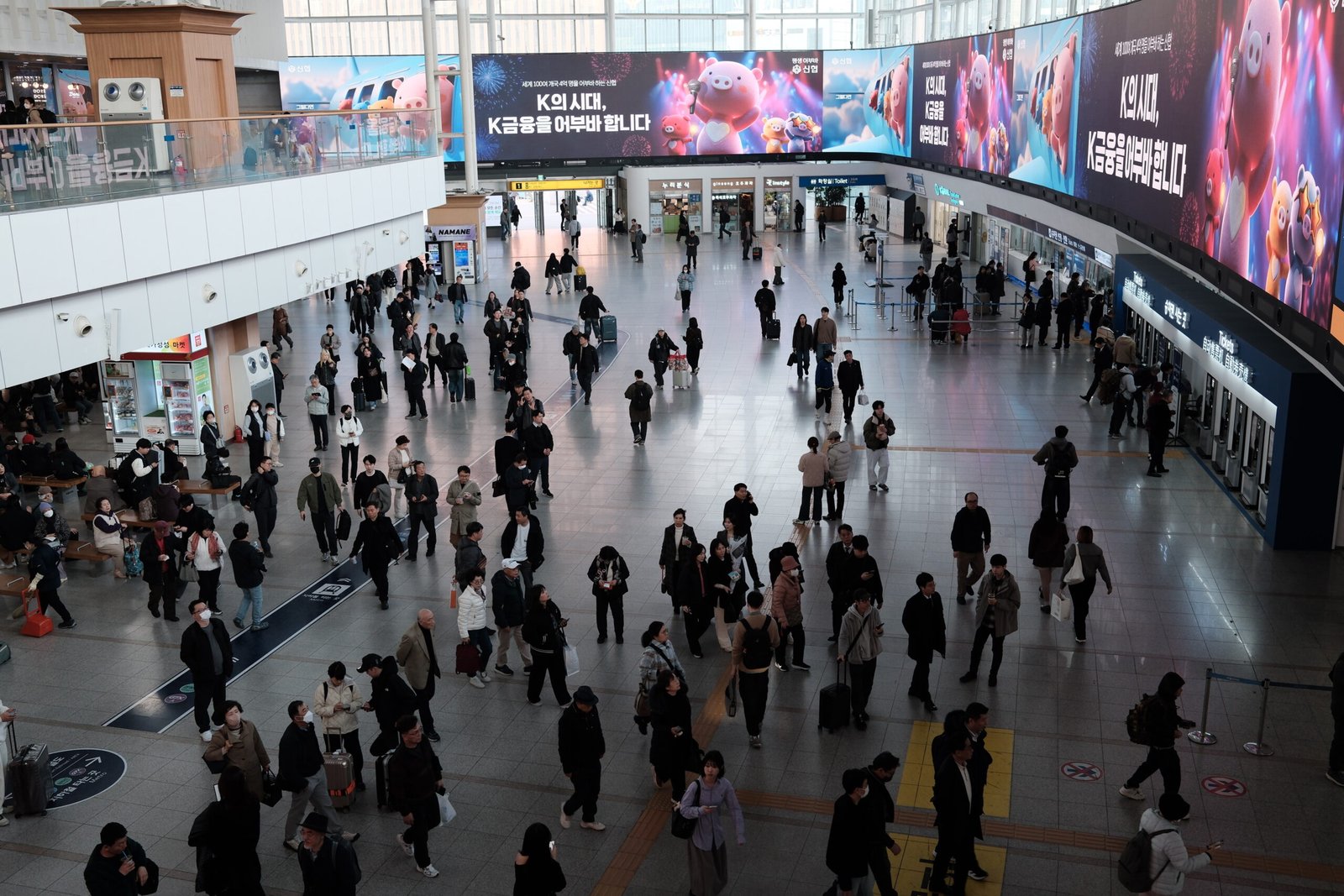 Travelers and ticket counters in Seoul Station’s main concourse, photographed in March 2026