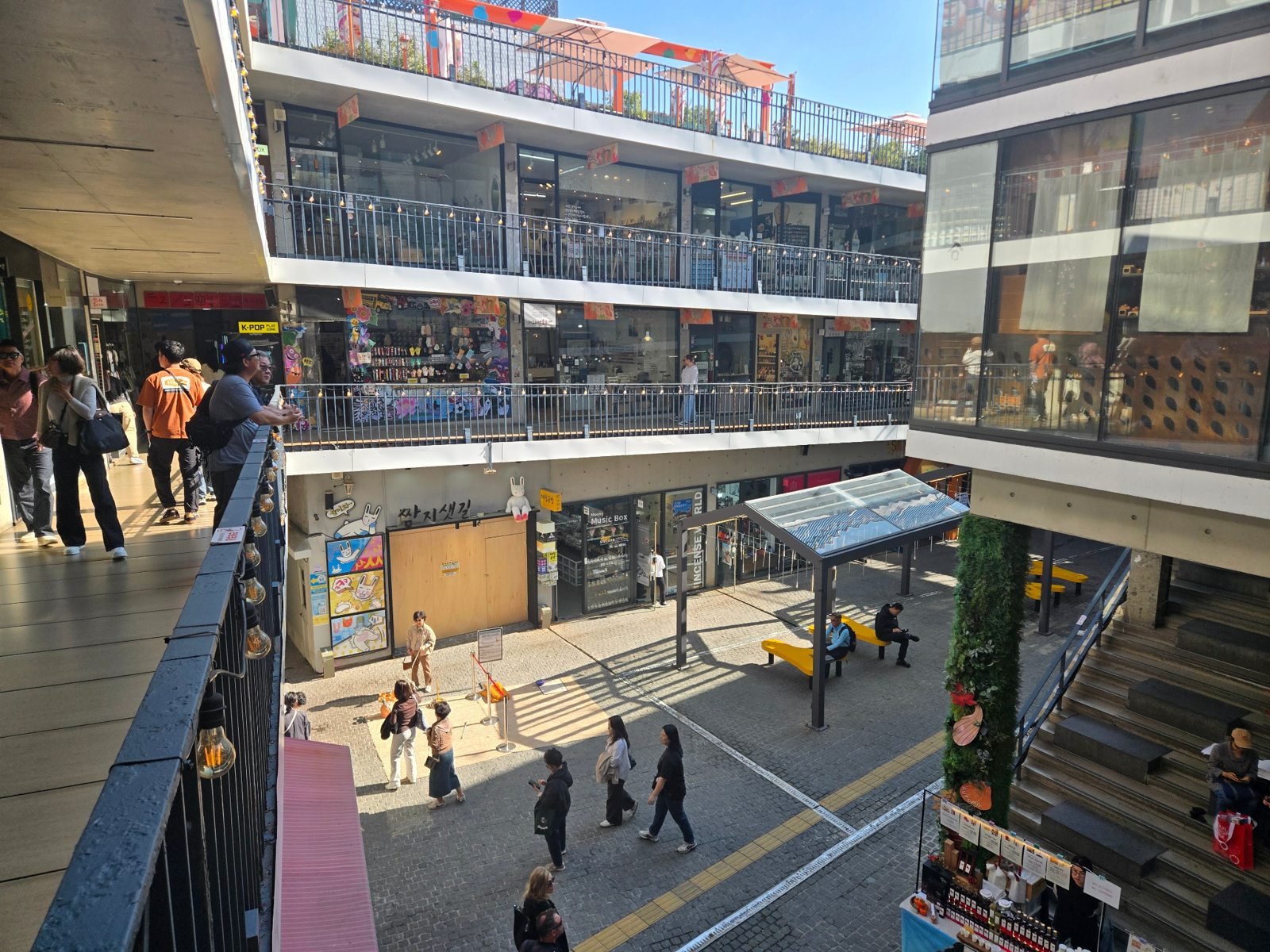 View from a Ssamziegil ramp across small shopfronts and down to the central courtyard